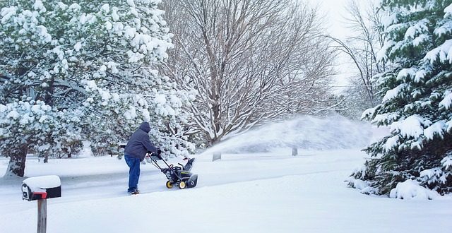 man using a snowblower
